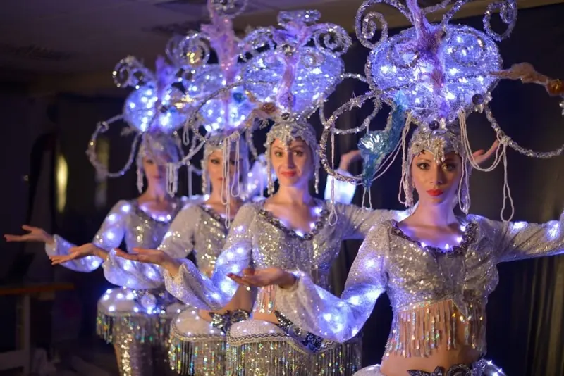 LED dancers in Singapore wearing light-up showgirl costumes and glowing headdresses